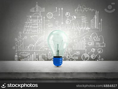 Conceptual image of light bulb on wall with sketches of ideas. Brigth ideas