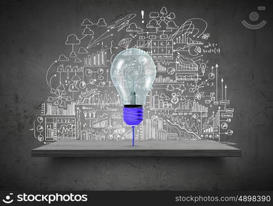 Conceptual image of light bulb on wall with sketches of ideas. Brigth ideas