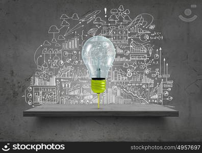 Conceptual image of light bulb on wall with sketches of ideas. Brigth ideas