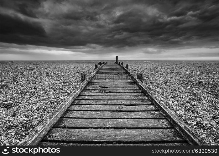 Conceptual image of path to nowhere in black and white beach landscape