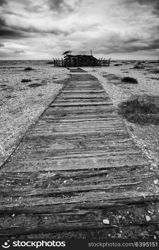 Conceptual image of path to nowhere in black and white beach landscape