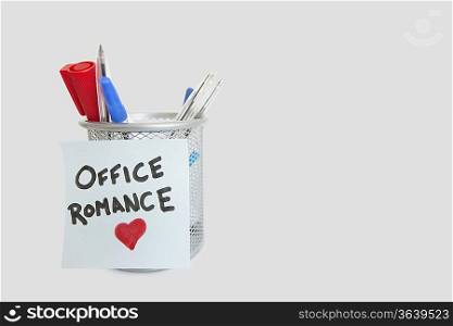 Conceptual image of sticky notepaper with heart shape depicting office romance