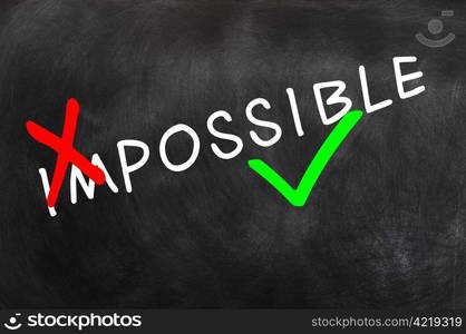 Conceptual image of the word impossible written in chalk on a blackboard