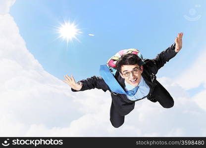 Conceptual image of young businessman flying with parachute on back