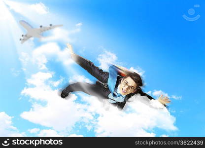 Conceptual image of young businessman flying with parachute on back