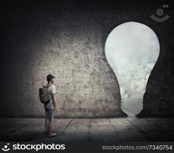 Conceptual image with a person standing in a dark room, in front of a bulb shaped doorway. Escape opportunity, entrance to another world.