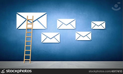 Conceptual image with ladder reaching email symbol