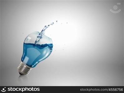 Conceptual image with light bulb filled with clear water. Light bulb with water