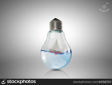 Conceptual image with light bulb filled with clear water. Light bulb with water