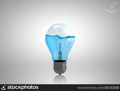 Conceptual image with light bulb filled with clear water. Light bulb with water