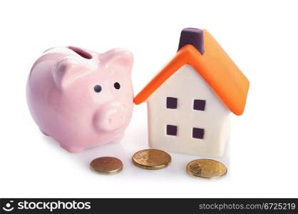conceptual image with piggy bank, coin and house