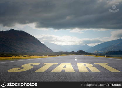 Conceptual image with word start on asphalt road. Start your way