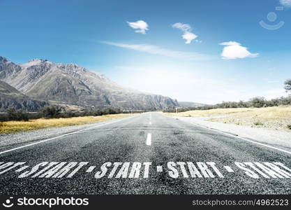 Conceptual image with word start on asphalt road. Start your way