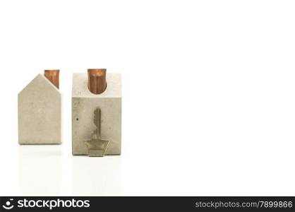 Conceptual Key and Miniature Homes with Copy Space. Conceptual Single Key and Miniature Homes on White Background with Copy Space on the Right Side.