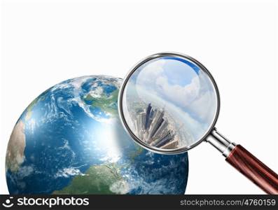 conceptual mini planet with a city on it. Conceptual mini planet with skyscrapers on it under a magnifying glass. Elements of this image are furnished by NASA