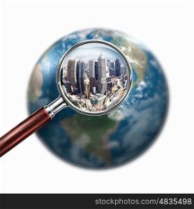conceptual mini planet with a city on it. Conceptual mini planet with skyscrapers on it under a magnifying glass. Elements of this image are furnished by NASA