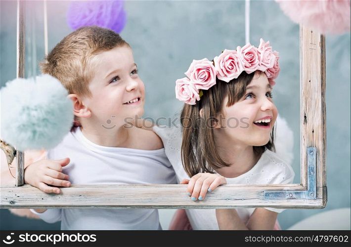 Conceptual photo of children holdng a photo frame
