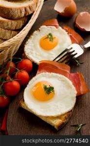 conceptual photo of english breakfast with fried eggs and bacon on wooden table