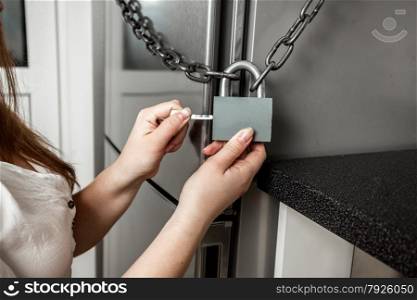 Conceptual photo of image hanging lock on refrigerator