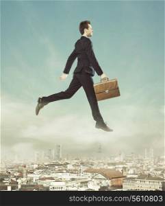 Conceptual photo of jumping businessman