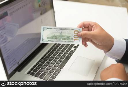 Conceptual photo of online payment system. Man sending money with computer