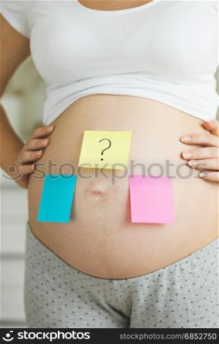 Conceptual photo of pregnant woman making choice