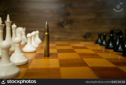 Conceptual photo of using bullet instead of chess piece
