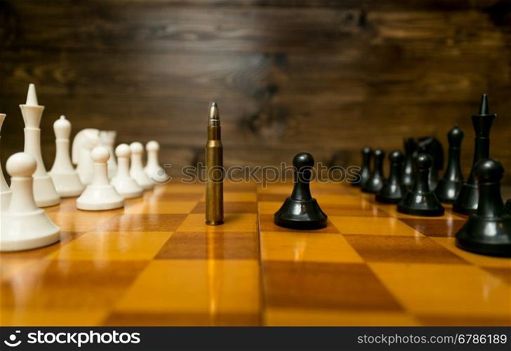 Conceptual photo of using bullet instead of chess piece. Concept of military power