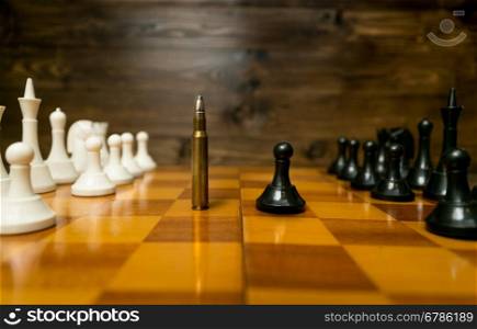 Conceptual photo of using bullet instead of chess piece. Concept of military power