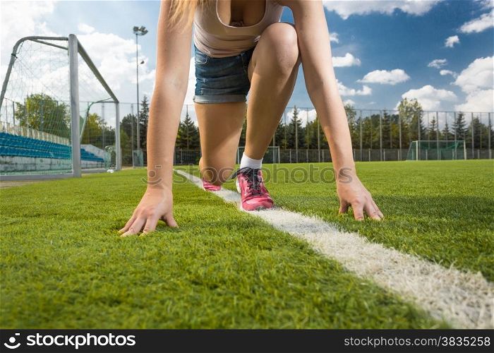 Conceptual photo of woman standing on start position on grass field