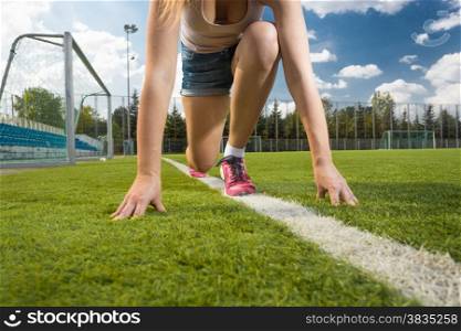 Conceptual photo of woman standing on start position on grass field