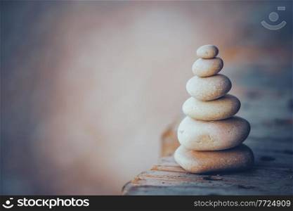 Conceptual Photo of Zen Balance. Pile of Pebbles on the Boardwalk on the Beach. Day Spa. Mind Body and Soul.. Stones Balance Background