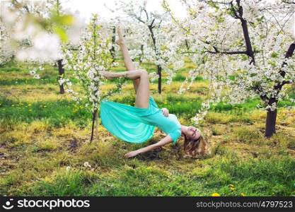 Conceptual picture of a lady levitating in the garden