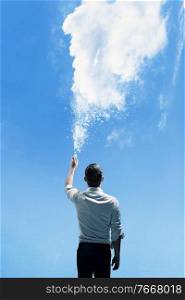 Conceptual picture of a man sprinkling a dense cloud