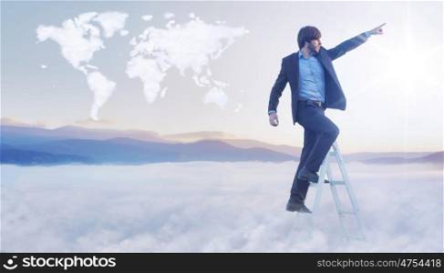 Conceptual picture of businessman over the cloud world map