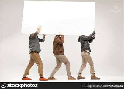 Conceptual picture of three guys carrying the empty board