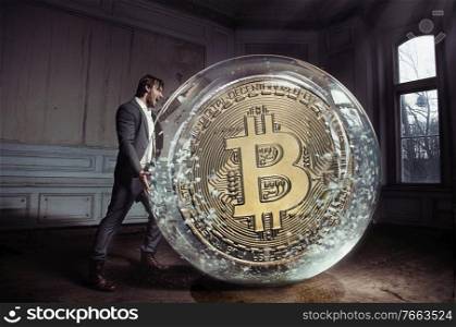 Conceptual portrait of a handsome, elegant businessman carrying a bitcoin 
