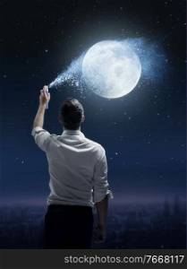 Conceptual portrait of a joyful man sprinkling a moon