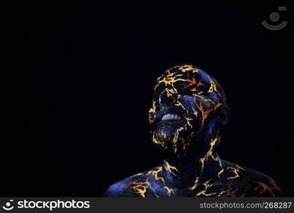 Conceptual Portrait of a man painted in fluorescent UV colors and looks like Neon lava. Man's Face Painted in Neon UV Lava