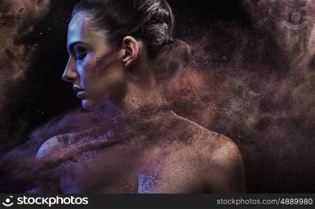 Conceptual portrait of a woman in the middle of a sand storm