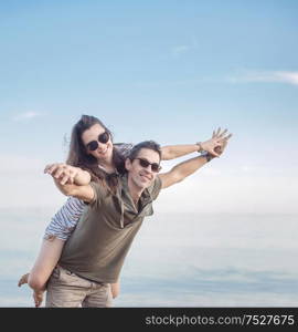 Conceptual portrait of a young, cheerful married couple on vacation