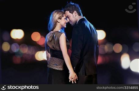 Conceptual portrait of a young couple in elegant evening dresses