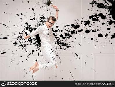 Conceptual portrait of a young jumping painter