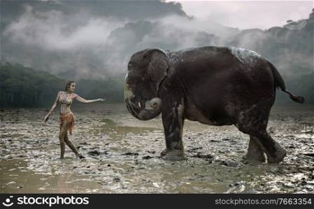 Conceptual portrait of a young, senusal tamer with an elephant