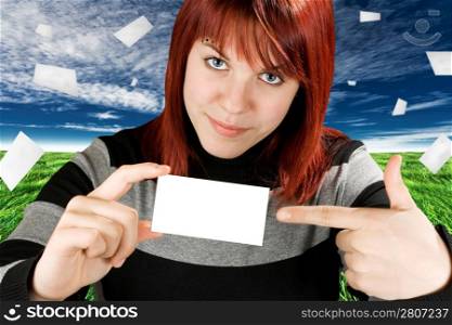Conceptual shot of a business vision and competitive advantage. Cute redhead girl pointing at a unique business or greeting card. Studio shot.