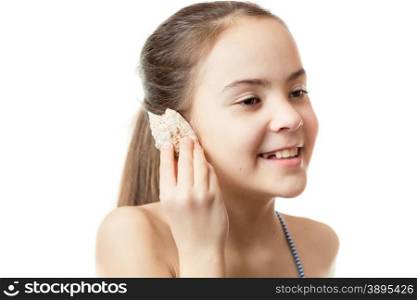Conceptual shot of cute girl listening to ocean in the shell
