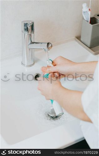 Conceptual shot of electrical toothbrush over a orange background with copy space