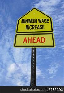 conceptual sign with words minimum wage increase ahead over blue sky