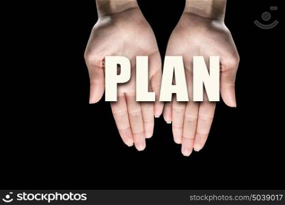Conceptual word in palms. Male hands on dark background showing in palms word plan