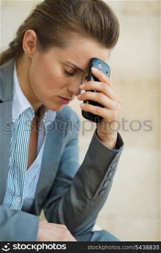 Concerned business woman with mobile phone